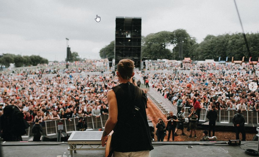Sam Bowden performing on stage with Neck Deep